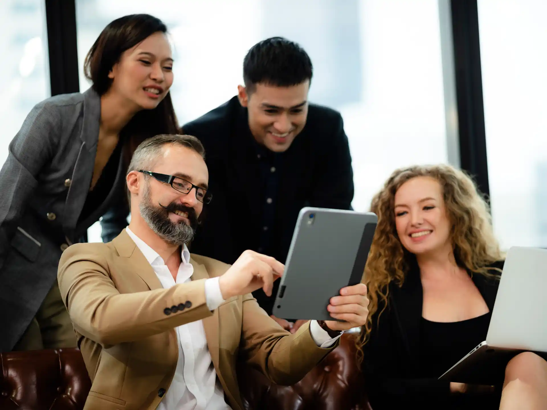 Team of business partners viewing good results from website by Centrix