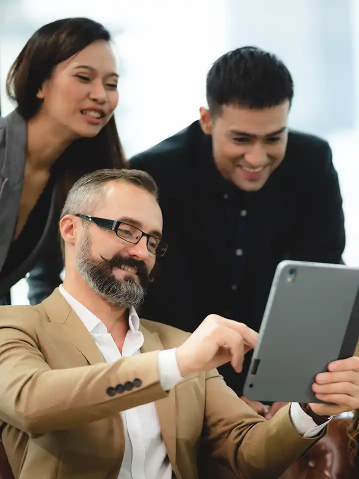 Team of business partners viewing good results from website